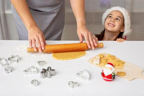 Woman's hands in a gray apron, roll out the dough for Christmas cookies with a Stock Photos