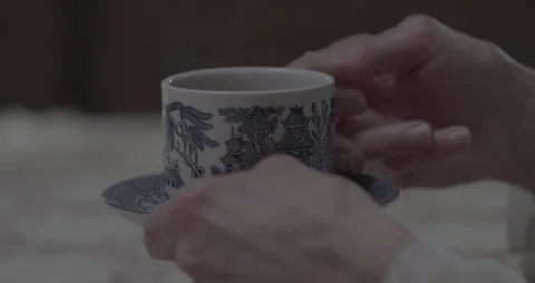 Woman's hands grip and drink Tea / Coffee from a fine china cup and saucer Stock Footage 211447464