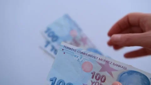 Womans hands hands counting Turkish lira  putting it one by one on white Stock Footage 146577284