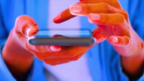 Woman's hands hold and swipe on mobile phone screen in blue background Stock-Footage 341802088
