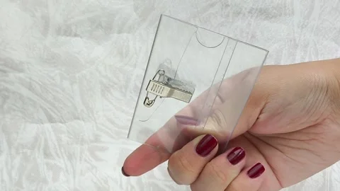 A womans hands hold a badge for a student, a consultant in a store. Stock Footage 314308151