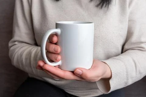 Woman's hands hold a pristine white mug, providing a perfect canvas Stock Photos