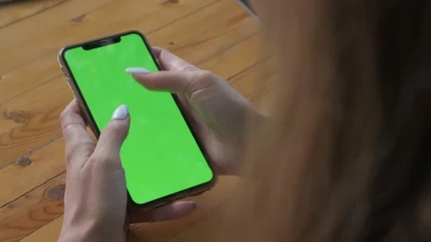 Womans hands hold smartphone which green screen Stock Footage 208173630
