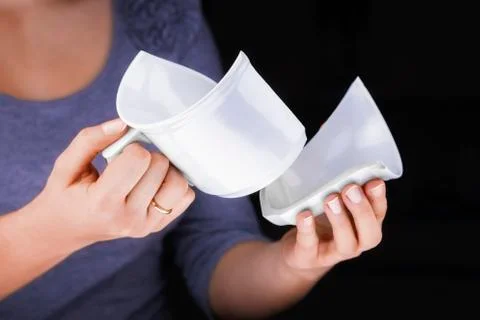 Woman's hands holding a broken white mug Stock Photos