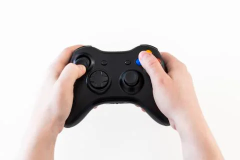 Woman's hands holding a controller to play video games Photos