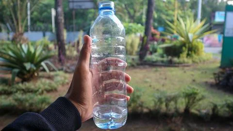 Woman's hands holding empty plastic bottles- close-up Stock Photos