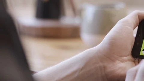 Woman's hands holding iPhone horizontally and her fingers sliding on the chroma Stock Footage 119518596