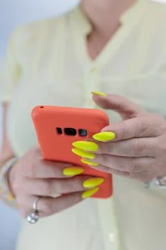 Woman's hands holding a large red smartphone Stock Photos