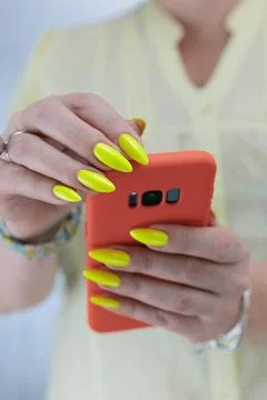 Woman's hands holding a large red smartphone Stock Photos