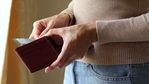 Woman's hands holding leather wallet with Malaysian ringgit cash money. Stock Footage 303521659