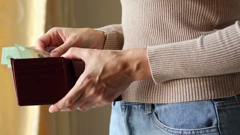 Woman's hands holding leather wallet with Vietnamese dong cash money banknotes. Stock Footage 303522862