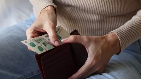 Woman's hands holding leather wallet with Russian ruble cash money banknotes. Stock Footage 303570870