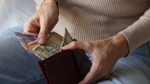 Woman's hands holding leather wallet with Indian rupeecash money banknotes. Stock Footage 303570947