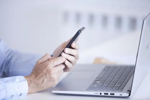 Woman's hands holding mobile phone while typing on the screen Stock Photos