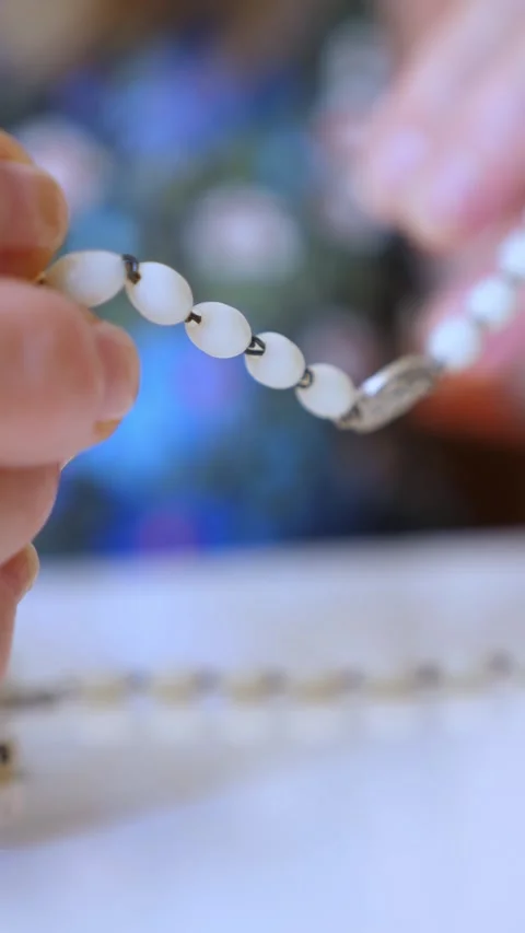 Woman's hands holding a rosary while praying with devotion Stock Footage 285662949