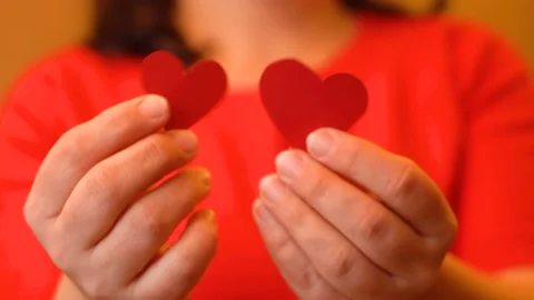 Woman's hands holding two hearts 4K Video stock 102440512