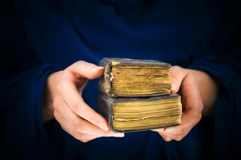 Woman's hands holding two old books Stock Photos