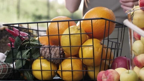 Woman's hands holding vegetables and taking from the basket. Shopping Stock Footage 139059155