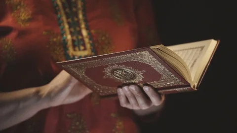 Woman's hands holds Koran - holy book of muslims Stock Footage 75697414