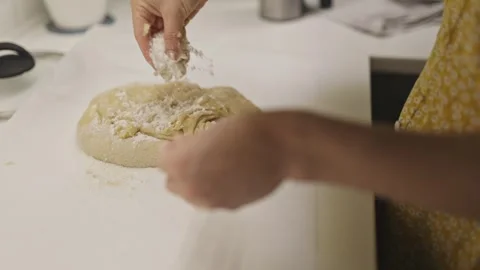 Womans hands kneading and folding dough for baking bread Stock Footage 320112311