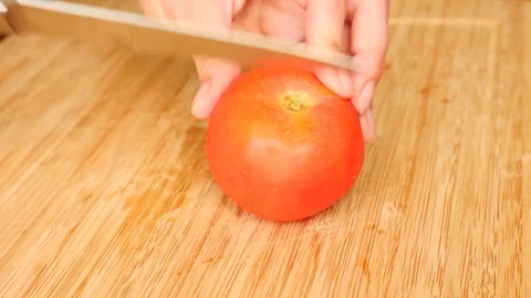 Woman's hands with a knife cut on a wooden board. 4k. Slow motion Stock Footage