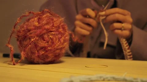 Woman's hands knitting. Ball of wool in foreground. Static 스톡 동영상 297774185