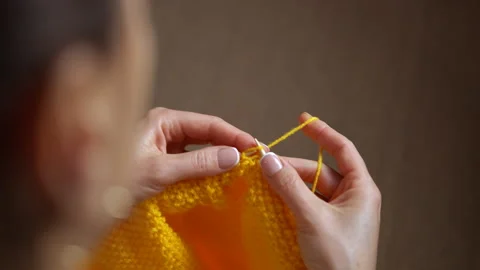 Woman's hands knitting yellow woolen fabric Video stock 344315053