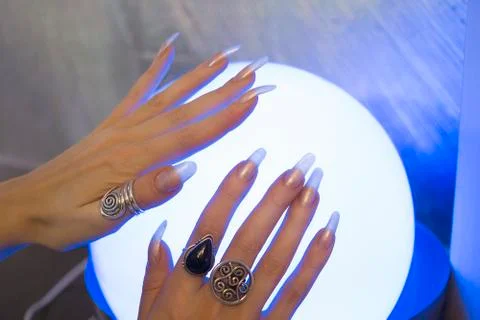 Woman's hands on the lamp 库存照片