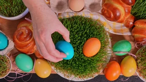 Woman's hands laying easter eggs on microgreen, close-up Stock Footage 169571179