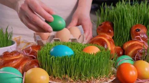 Woman's hands laying easter eggs on microgreen, close-up Stock Footage 169571434
