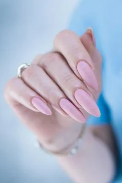 Woman's hands with long nails and a light pink color Foto stock