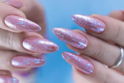 Woman's hands with long nails and a light pink color Stockfoto's