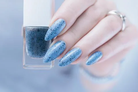 Womans hands with long nails light gray blue manicure Stock-Fotos