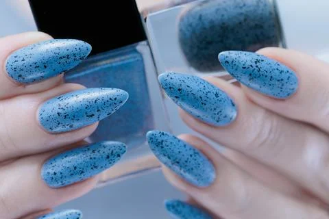 Womans hands with long nails light gray blue manicure Stock-Fotos