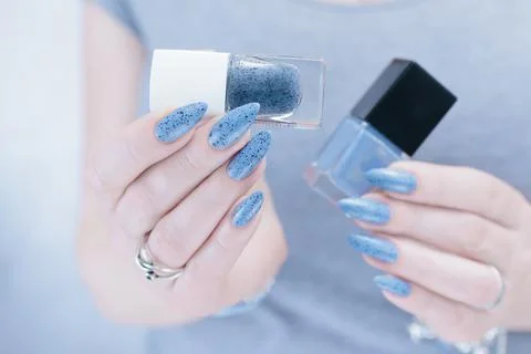 Womans hands with long nails light gray blue manicure 스톡 사진