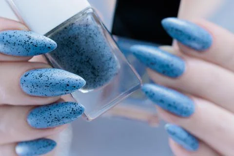 Womans hands with long nails light gray blue manicure Stock Photos