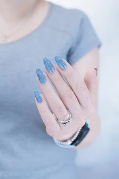 Womans hands with long nails light gray blue manicure 库存照片