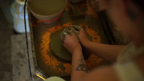Woman's hands makes a pot on pottery wheel Stock Footage 71523963