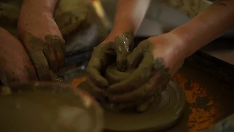 Woman's hands makes a pot on pottery wheel Stock Footage 71524338