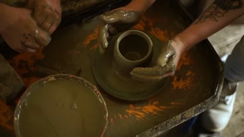 Woman's hands makes a pot on pottery wheel Stock Footage 71524993
