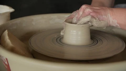 Woman's hands making a clay vase on a potter's wheel in a workshop. Stock Footage 267820472