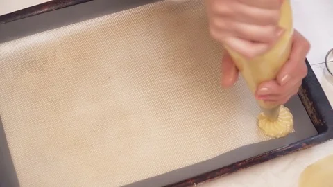 Woman's hands making small eclairs with the help of pastry bag Stock Footage
