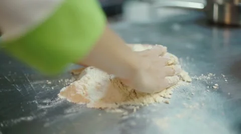 The woman's hands is mixing the dough at the kitchen table Stock Footage 57496262