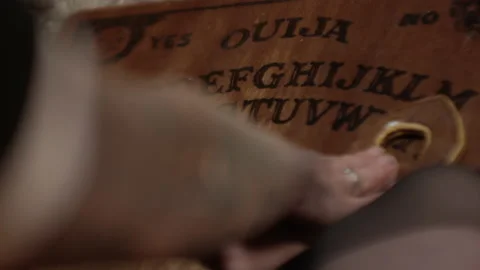 Woman'S Hands Moving Planchette Over Ouija Board 库存影片 147512927
