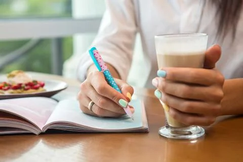 Woman's hands with notebook Stock Photos