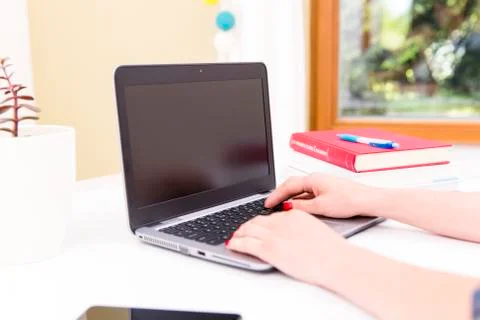 Womans hands on notebook working in clean and bright office, at home, freelan Stock Photos