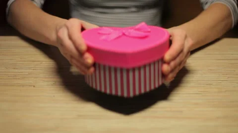 Woman's hands open box with present for Valentine's Day Stock Footage 45795748