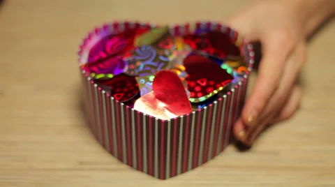 Woman's hands open box with present for Valentine's Day Stock Footage 45795845
