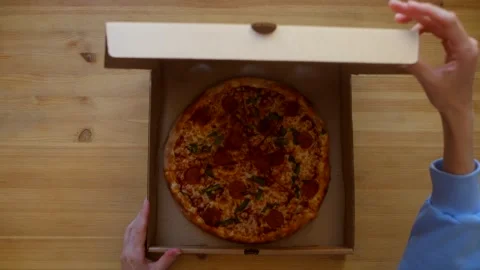 Woman's hands open delivery box with pizza Stock Footage 245372279