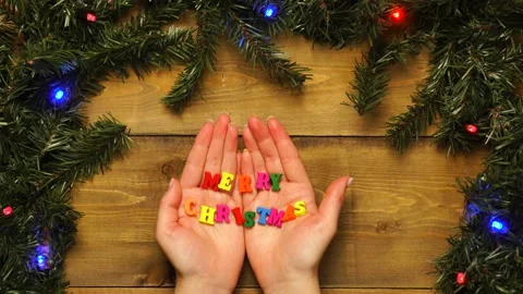 Woman's hands open in frame with words merry christmas. Top view, a place for Stock Footage 143232440